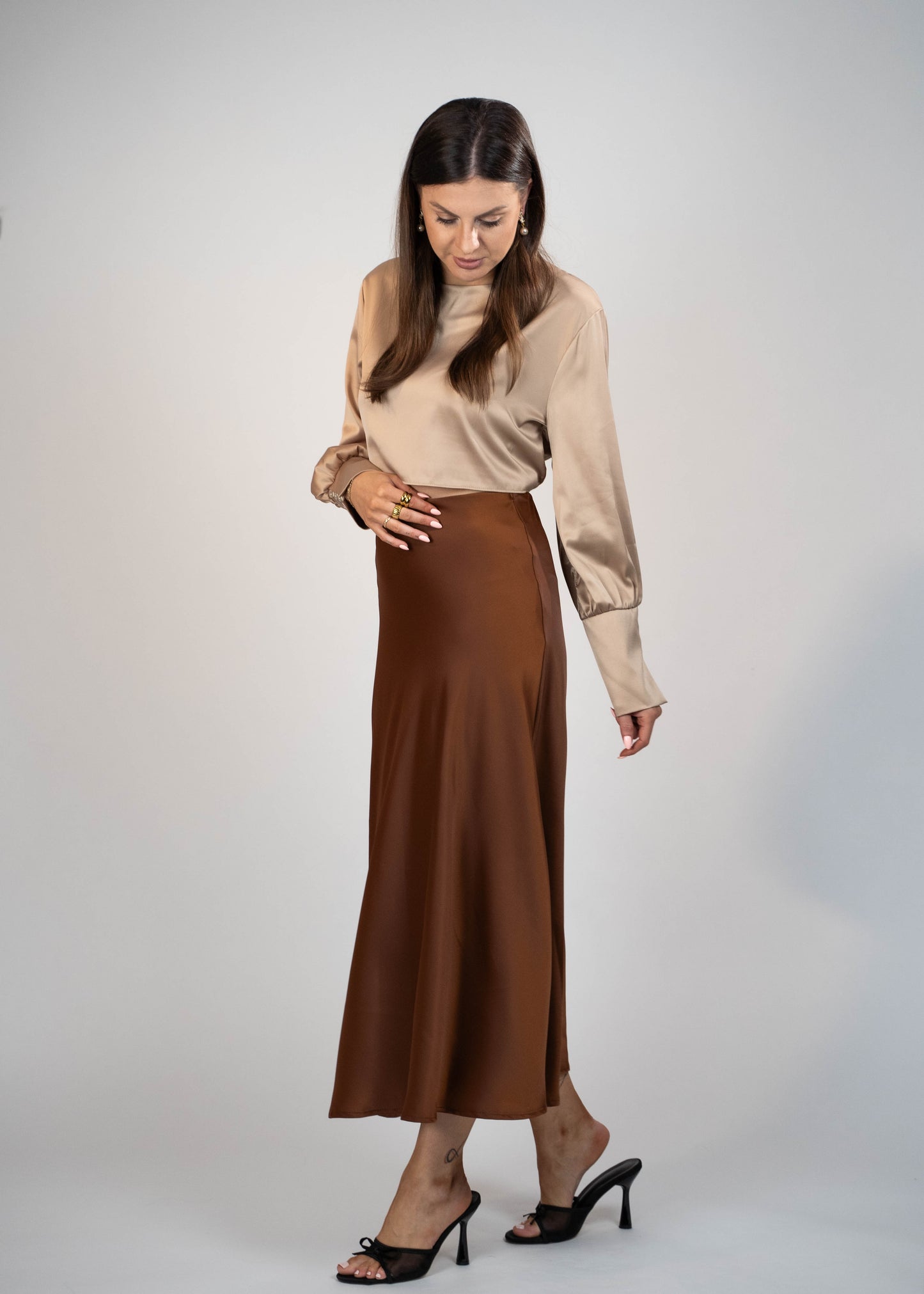 Elegant brown satin maxi skirt that’s easy to match with any outfit. Perfect for creating a sophisticated and versatile look