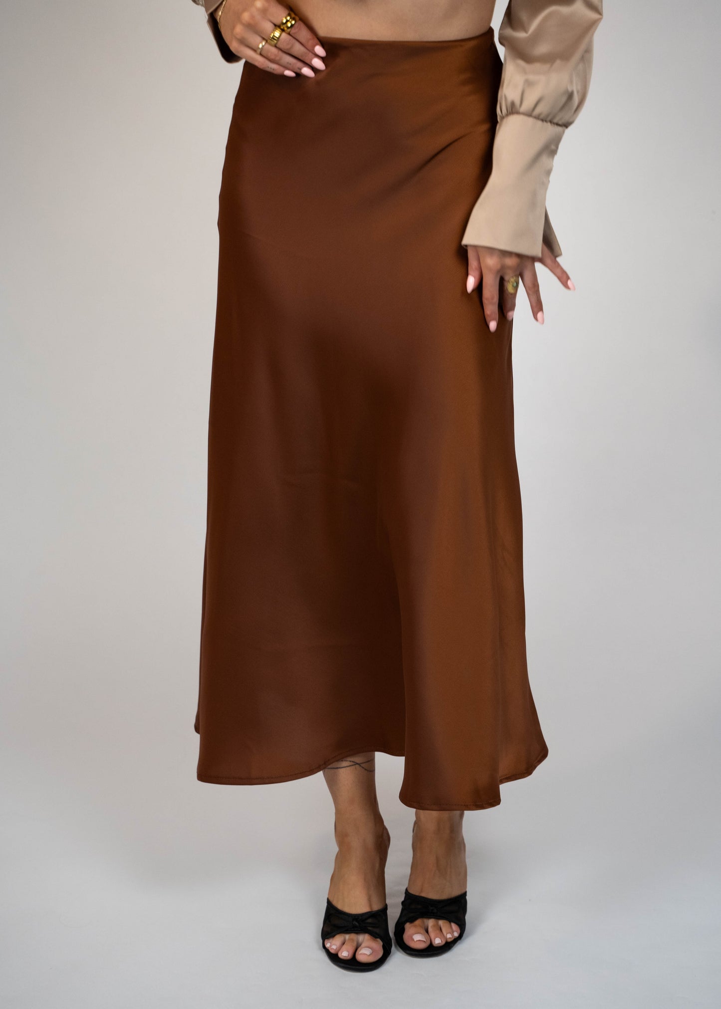 Elegant brown satin maxi skirt that’s easy to match with any outfit. Perfect for creating a sophisticated and versatile look