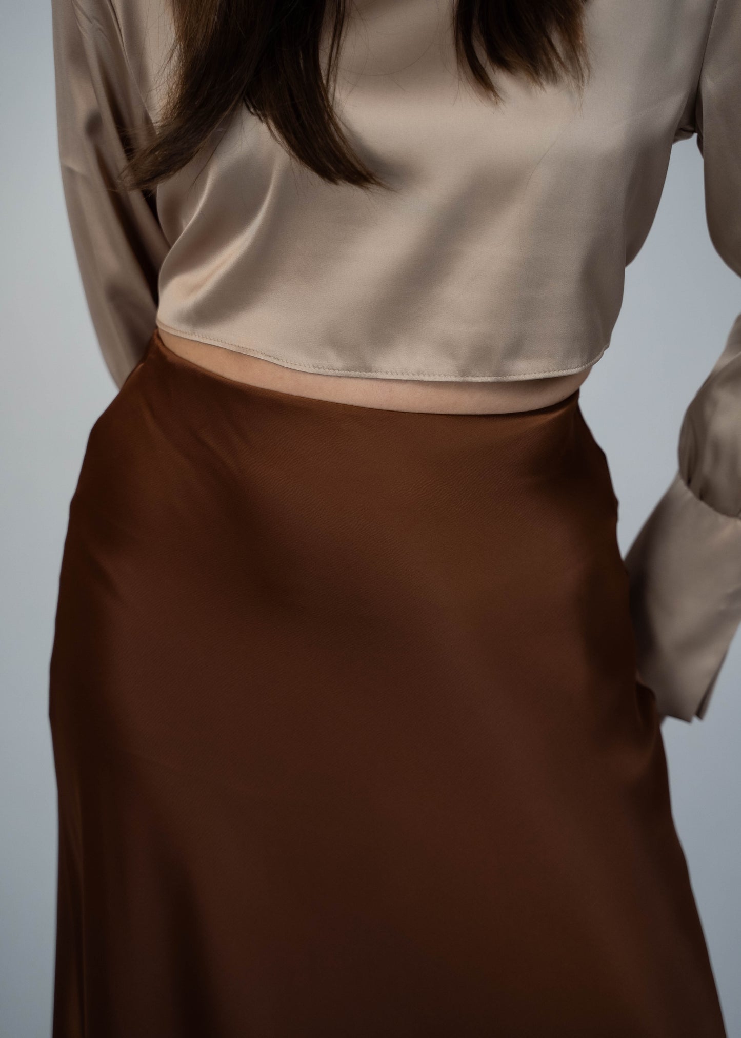 Elegant brown satin maxi skirt that’s easy to match with any outfit. Perfect for creating a sophisticated and versatile look